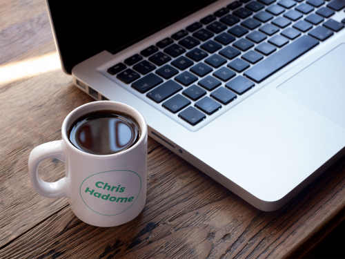 cup of coffee mockup near a macbook a16461