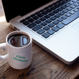 cup-of-coffee-mockup-near-a-macbook-a16461